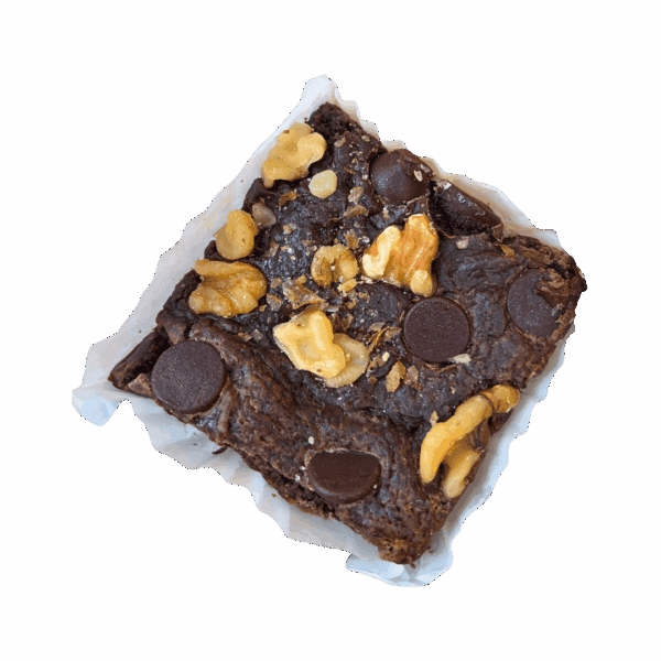 The WPM Original Triple Layer Brownies features a square chocolate brownie topped with chocolate chips and walnut pieces, presented in a white paper baking cup on a plain white background.