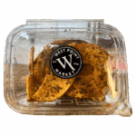 A clear plastic container labeled West Point Market contains several slices of herb-seasoned Bagel Crisps.