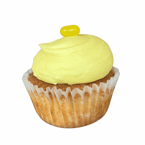 A cupcake with yellow frosting and a small yellow candy on top, in a white paper wrapper, set against a plain white background.