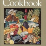 West Point Market Cookbook cover featuring an illustration of various fruits, vegetables, seafood, and cheese surrounding a whole fish, with the title and author name in red and white text.